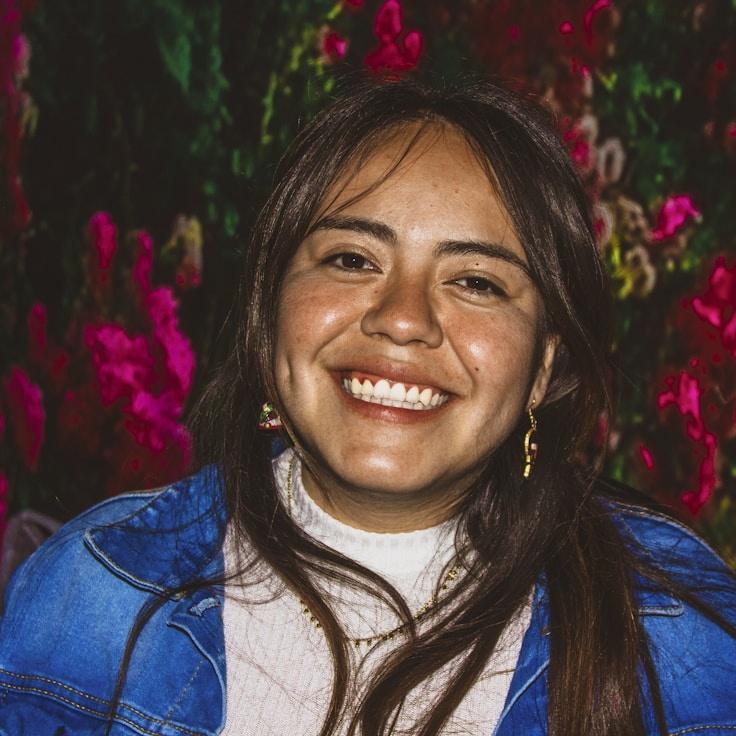 Avery Singh, Lead Design Curator at SoftMarbleVoyage, reviewing corporate floral arrangements